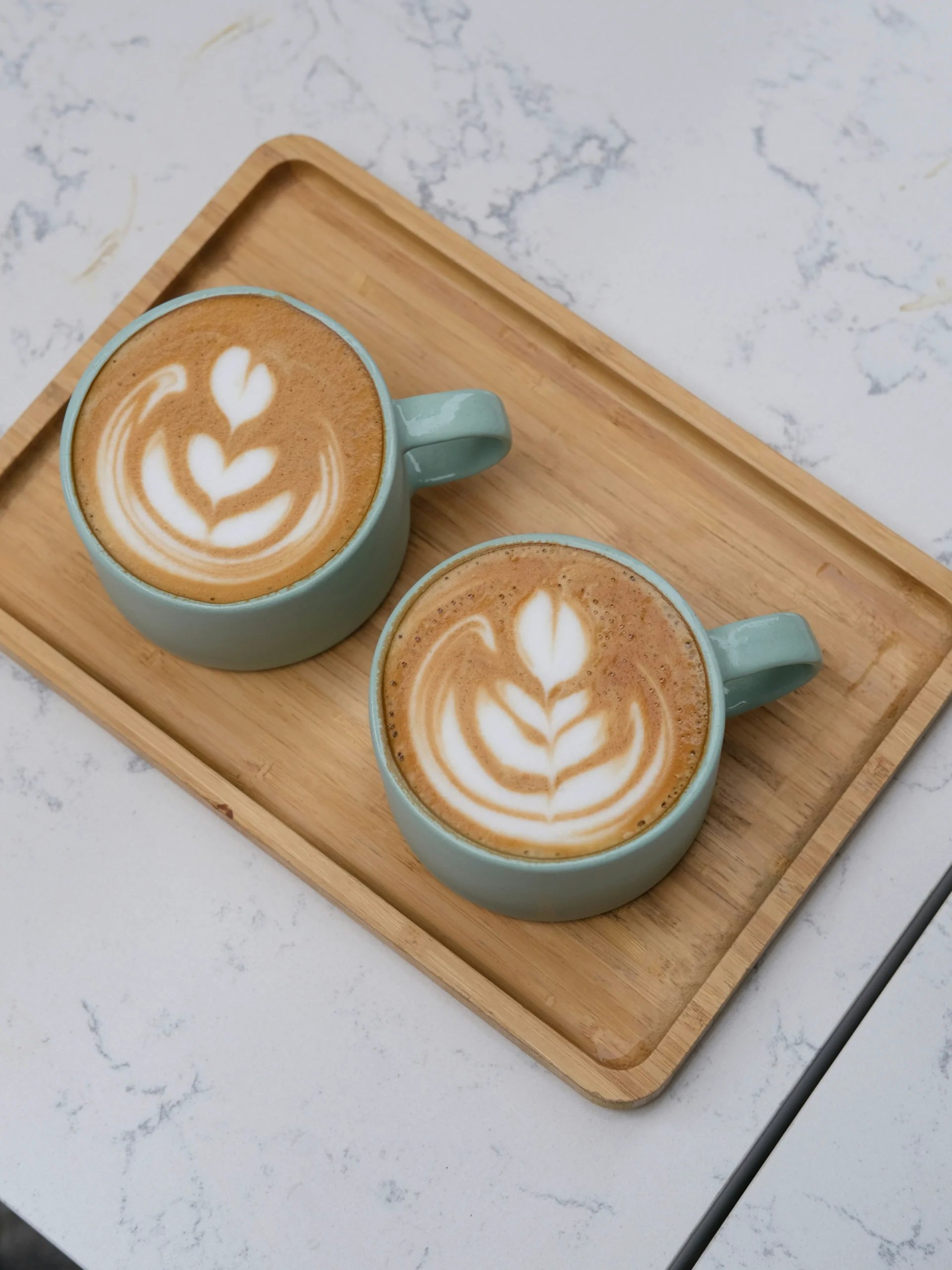 Two cups of coffee on a table during a brand strategy consultation meeting with Maslow Brand Consulting.